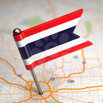 Small Flag of Kingdom of Thailand on a Map Background with Selective Focus.