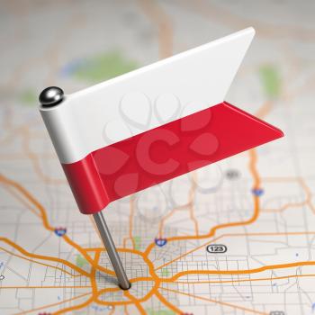 Small Flag of Republic of Poland on a Map Background with Selective Focus.