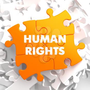Human Rights on Orange Puzzle on White Background.