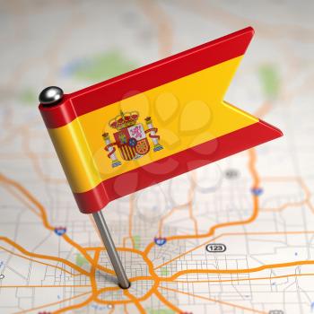 Small Flag of Spain on a Map Background with Selective Focus.