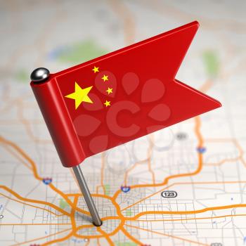 Small Flag of the People's Republic of China on a Map Background with Selective Focus.