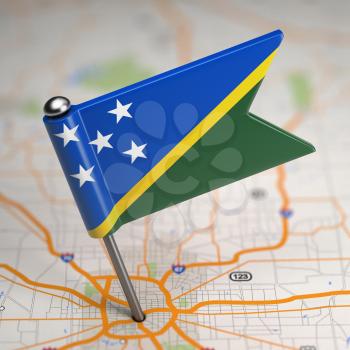 Small Flag of Solomon Islands on a Map Background with Selective Focus.