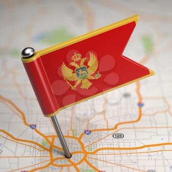 Small Flag of Montenegro on a Map Background with Selective Focus.