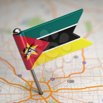 Small Flag of Mozambique on a Map Background with Selective Focus.