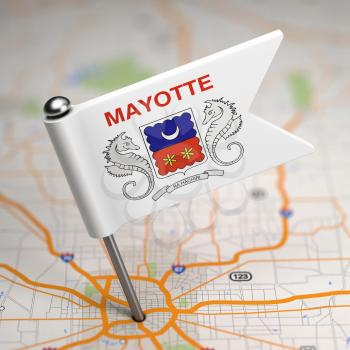 Small Flag of Mayotte on a Map Background with Selective Focus.