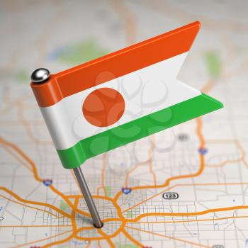 Small Flag of Niger on a Map Background with Selective Focus.