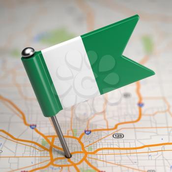 Small Flag of Nigeria on a Map Background with Selective Focus.