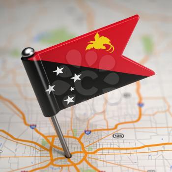 Small Flag of Papua New Guinea on a Map Background with Selective Focus.
