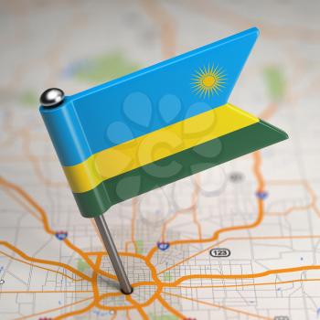Small Flag of Rwanda on a Map Background with Selective Focus.
