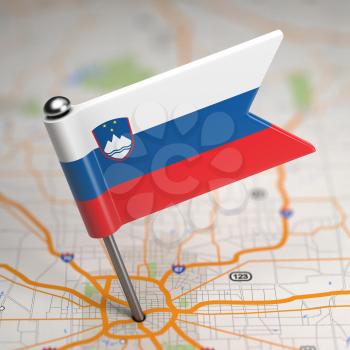 Small Flag of Slovenia on a Map Background with Selective Focus.