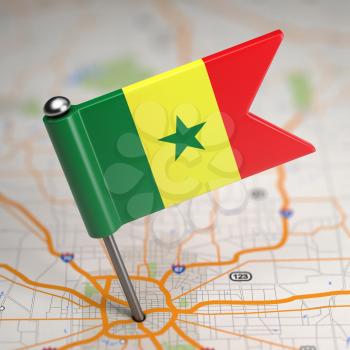 Small Flag of Senegal on a Map Background with Selective Focus.