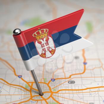 Small Flag of Serbia on a Map Background with Selective Focus.