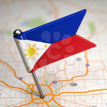 Small Flag of Philippines on a Map Background with Selective Focus.