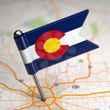 Small Flag of Colorado on a Map Background with Selective Focus.