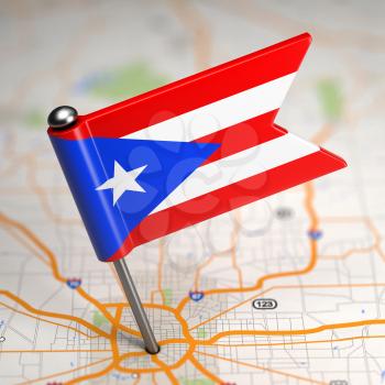 Small Flag of Puerto Rico on a Map Background with Selective Focus.