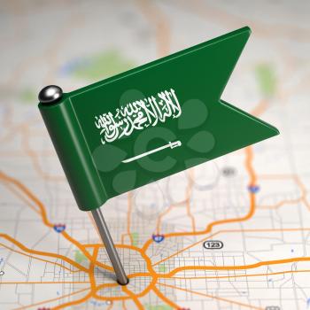 Small Flag of Saudi Arabia on a Map Background with Selective Focus.