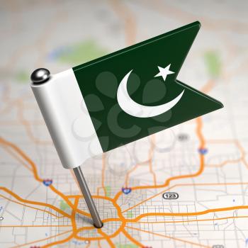 Small Flag of Pakistan on a Map Background with Selective Focus.