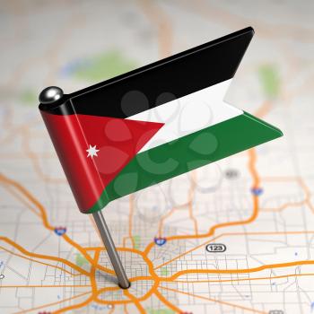 Small Flag of Jordan on a Map Background with Selective Focus.