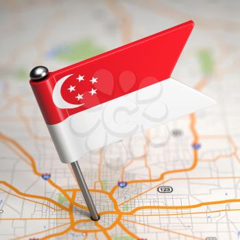Small Flag of Singapore on a Map Background with Selective Focus.