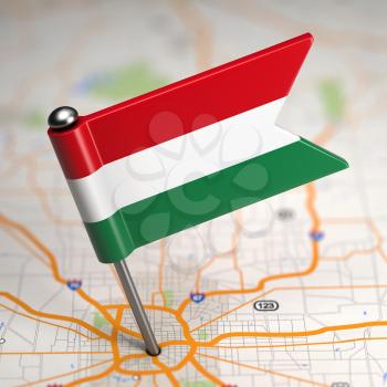 Small Flag of Hungary on a Map Background with Selective Focus.