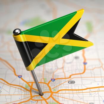 Small Flag of Jamaica on a Map Background with Selective Focus.
