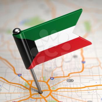 Small Flag of Kuwait on a Map Background with Selective Focus.