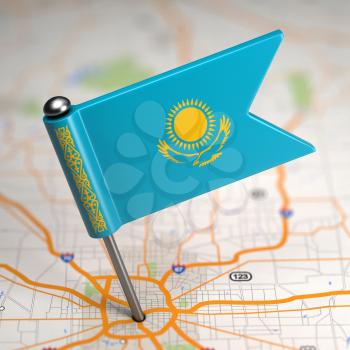 Small Flag of Kazakhstan on a Map Background with Selective Focus.