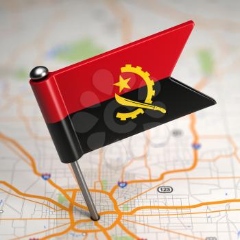 Small Flag of Angola on a Map Background with Selective Focus.
