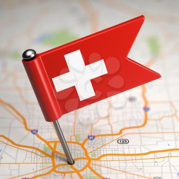 Small Flag of Switzerland on a Map Background with Selective Focus.