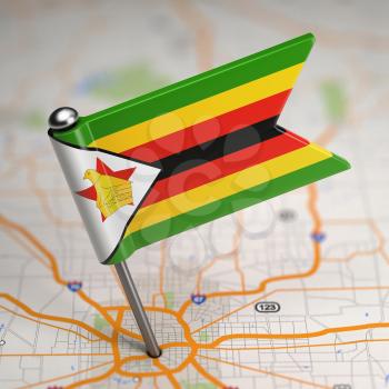 Small Flag Republic of Zimbabwe on a Map Background with Selective Focus.