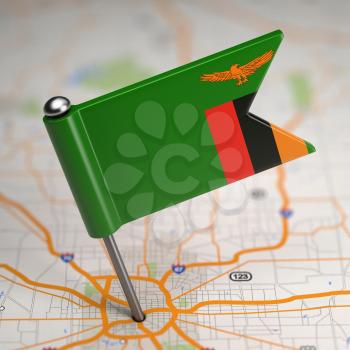 Small Flag Republic of Zambia on a Map Background with Selective Focus.