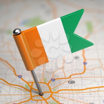 Small Flag Republic of Ivory Coast on a Map Background with Selective Focus.