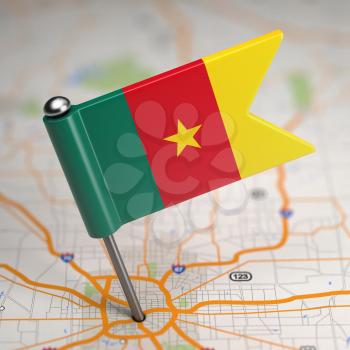 Small Flag Republic of Cameroon on a Map Background with Selective Focus.