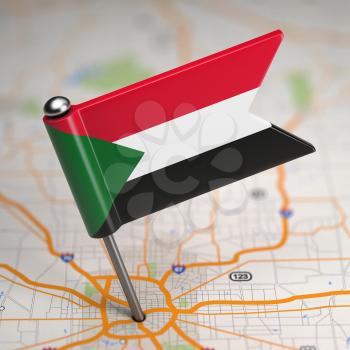 Small Flag Republic of the Sudan on a Map Background with Selective Focus.