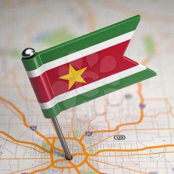 Small Flag Republic of Suriname on a Map Background with Selective Focus.