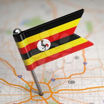 Small Flag Republic of Uganda on a Map Background with Selective Focus.