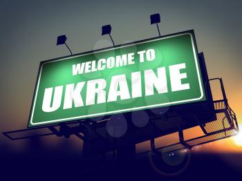 Welcome to Ukraine - Green Billboard on the Rising Sun Background.