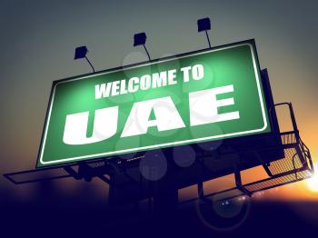Welcome to UAE - Green Billboard on the Rising Sun Background.