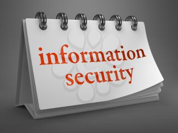 Information Security - Red Words on White Desktop Calendar Isolated on Gray Background.