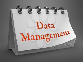 Data Management - Red Words on White Desktop Calendar Isolated on Gray Background.