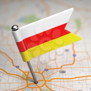 Small Flag of Republic of South Ossetia on a Map Background with Selective Focus.