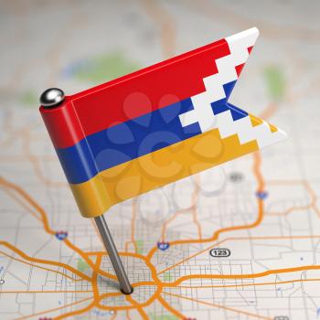 Small Flag of Nagorno-Karabakh on a Map Background with Selective Focus.