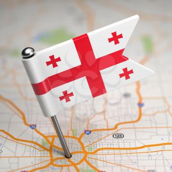 Small Flag of Georgia on a Map Background with Selective Focus.