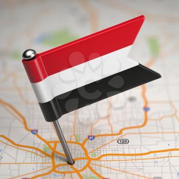 Small Flag of Yemen on a Map Background with Selective Focus.