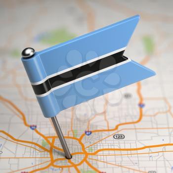 Small Flag of Republic of Botswana on a Map Background with Selective Focus.