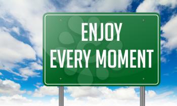 Highway Signpost with Enjoy Every Moment wording on Sky Background.
