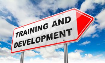 Training and Development - Inscription on Red Road Sign on Sky Background.