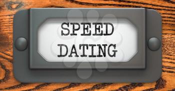 Speed Dating - Inscription on File Drawer Label on a Wooden Background.
