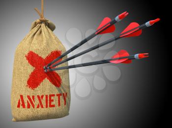 Anxiety - Three Arrows Hit in Red Mark Target on a Hanging Sack on Grey Background.