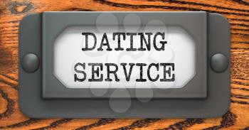 Dating Service  - Inscription on File Drawer Label on a Wooden Background.
